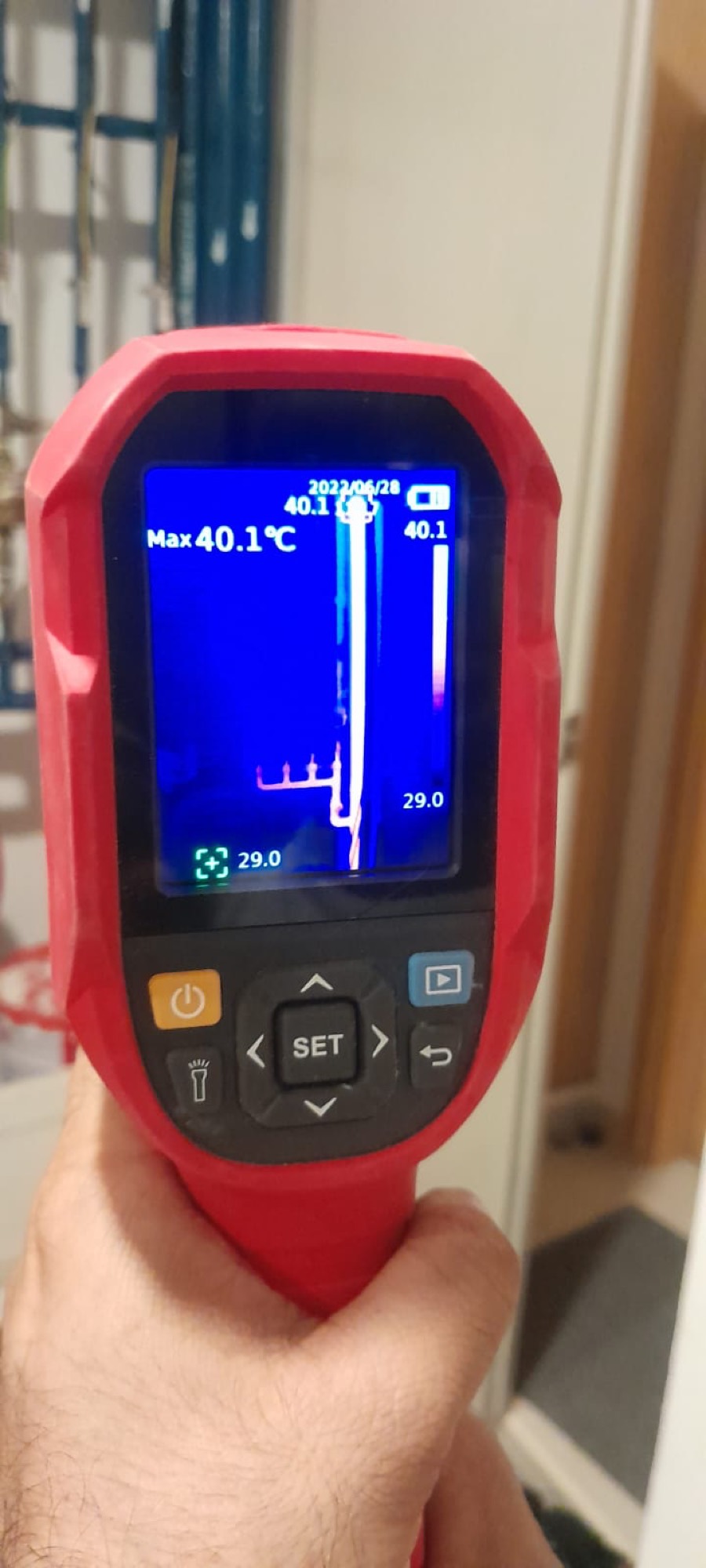 Electrician using a thermal imaging camera reading 40.1 degrees to find an electrical hot spot
